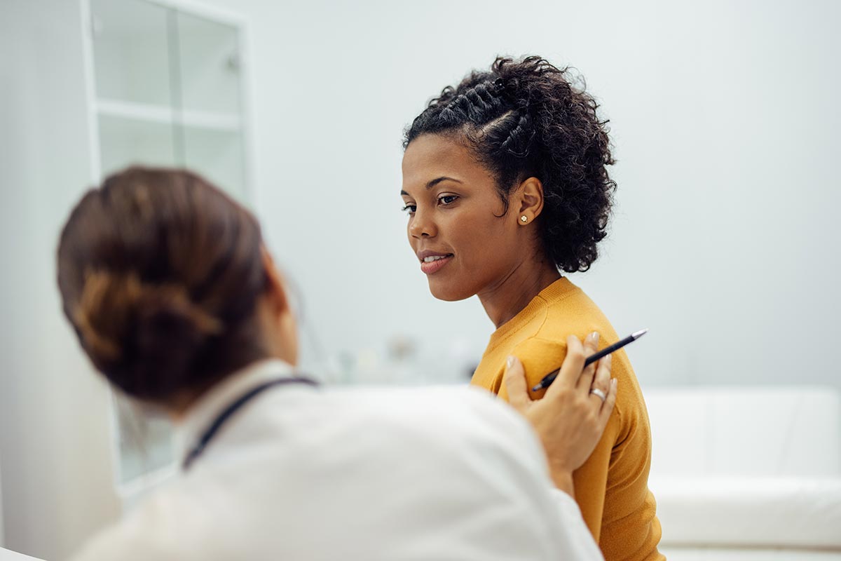 female doctor reassuring female patient