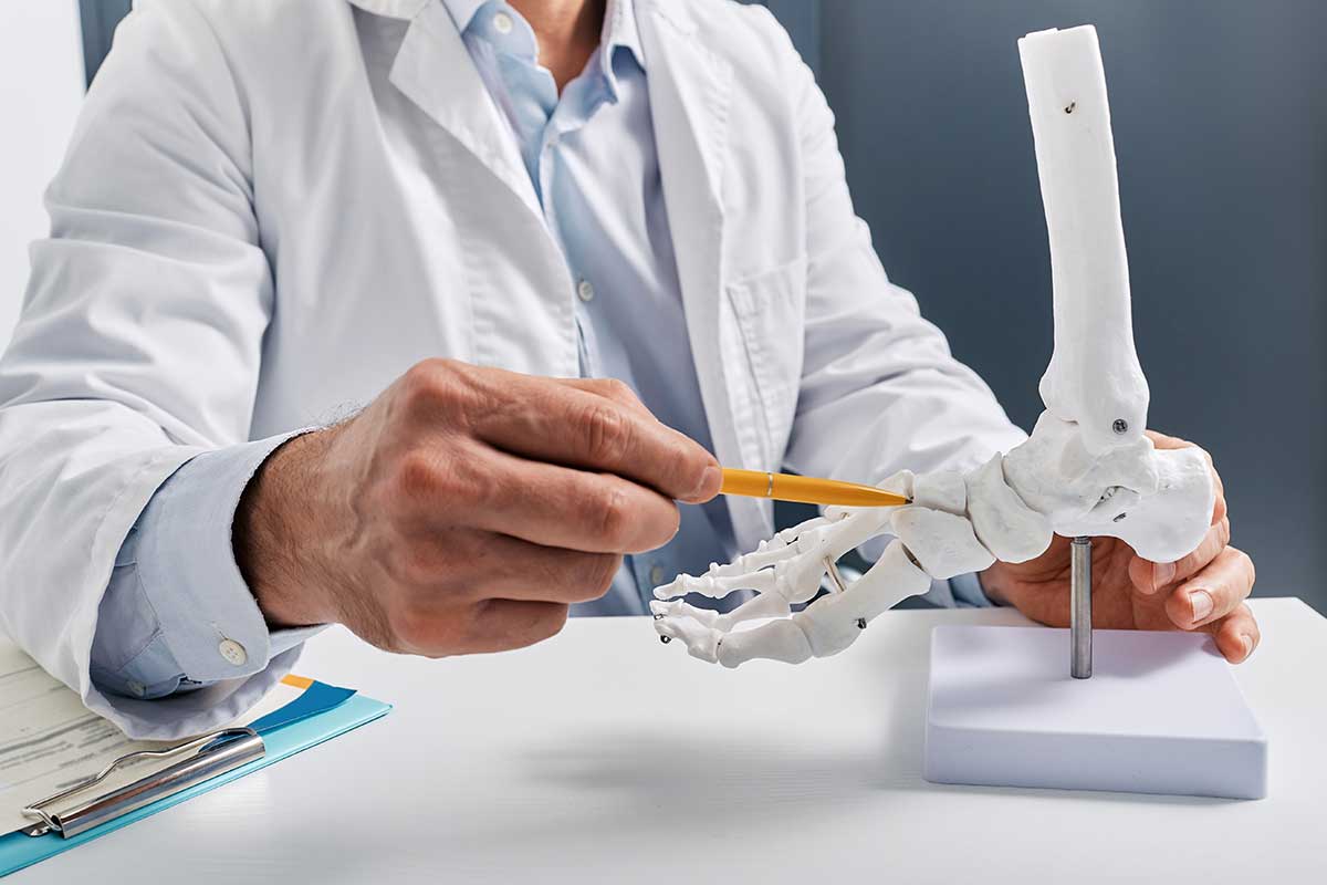 SJMC podiatrist pointing to foot bone