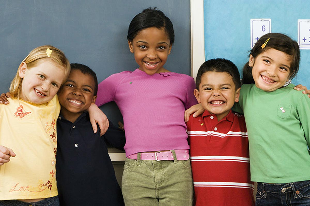 Group of diverse students standing together in classroom