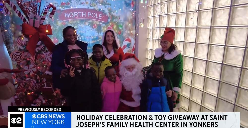 Saint-Joe-Christmas-Giveaway featured image for Hundreds of kids celebrating the Christmas spirit at Saint Joseph’s Family Health Center. WCBS reporter Nick Caloway shows us all the fun! post